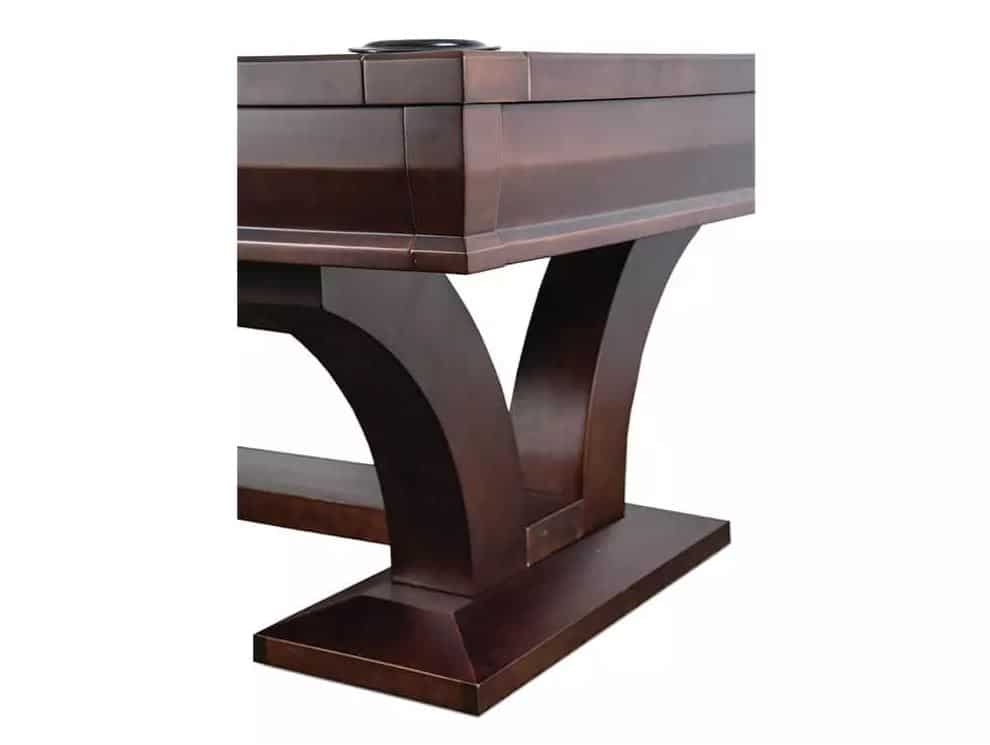 Dark wooden piano with thick curved legs resting on a rectangular base, shown from a side angle.
