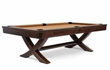 Dark wood pool table with beige felt, six pockets, and curved cross-legged supports.