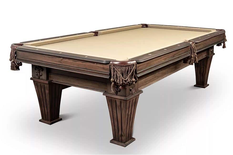 Dark wooden billiards table with beige felt and tasselled pockets on a white background.