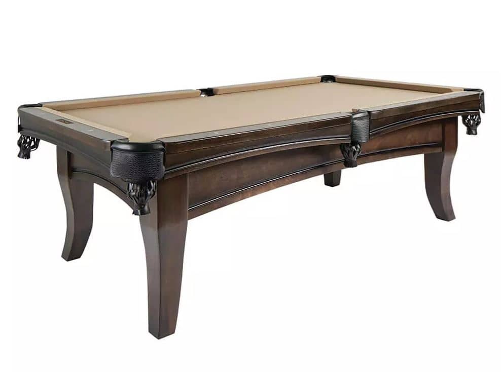 Dark wood pool table with tan felt and ornate leather-pocketed corners, set against a white background.