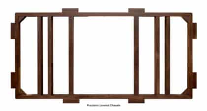 Wooden precision-leveled chassis frame with multiple vertical supports and end notches, likely a structural jig.