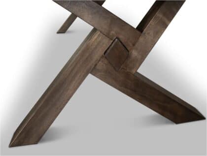 Close-up of interlocking dark wooden legs forming a sturdy joint on a light gray surface.