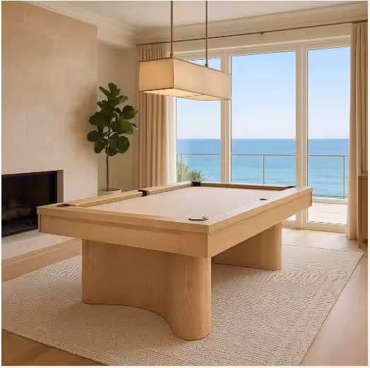 Oceanside20LIFESTYLE20photo-sA2HEyVYQC2oAbRPPx4cMDw0iAr19G | Oceanside | West Penn Billiards Light wood pool table in a bright living room, with a fireplace, potted plant, and ocean view through large windows,